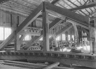 A section of roof trusses takes form in the carpenter shop, to be filled later with decorative carving. Each truss had to be designed individually because of the curve in plan of the walls on which the roof rested.
