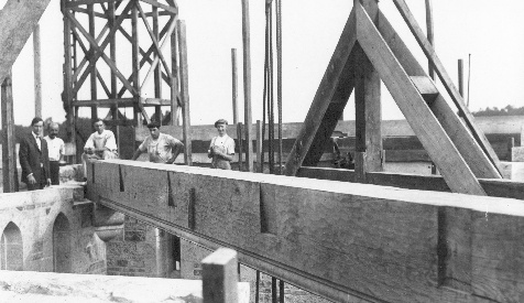 This beam spans the tower diagonally and supports the bell deck above the lantern. Pitcairn and Bowman are at left.