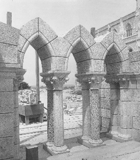 This triad of lancet windows stands at the west end of the undercroft, on the ground floor of the Council Hall. The cleanness of the granite is enhanced by the delicate Romanesque carvings on the small dividing columns.