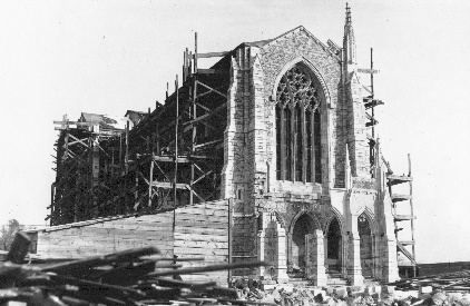 The west porch, partially erected in stone, undergoes 