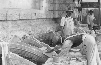 These workmen, typical of the crowd that trooped up the hill to the church from the Bryn Athyn railroad station each day, are setting the ribs for the vaulted roof of the west porch, beneath the west window.