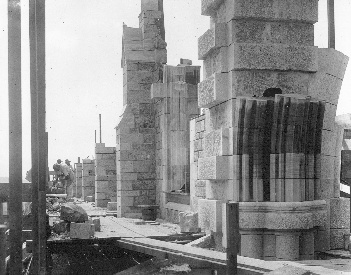 In the foreground a rising tower pier reveals the intricacies of design and execution, in the uniting of utilitarian strength with formal beauty. Beyond stand the buttresses of the nave clerestory.