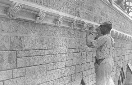 A striking picture of the artisan working in full view of the whole for which he is creating a part, in happy contrast to the divisive practices of modern economy. He is carving rosettes from solid blocks of limestone—rosettes that will run in  endless variety around the nave just below the cornice.